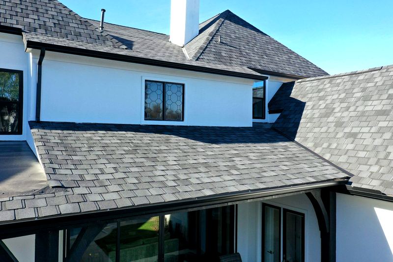 Close-up of a newly installed gray architectural shingle roof by Benchmark Roofing and Construction